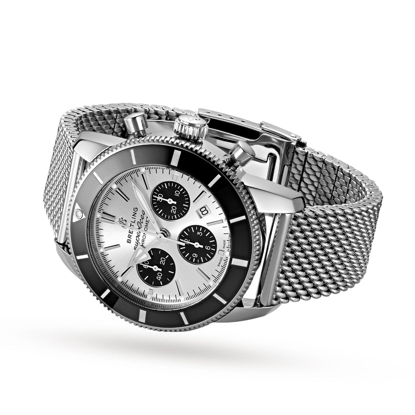 Breitling Superocean Heritage B01 Chronograph 44 featuring a silver case, black accents, and a stainless steel mesh band, shown on a white background.