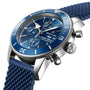 A close-up of the Breitling Superocean Heritage Chronograph 44 reveals its blue dial with three subdials and a blue textured strap, powered by the precise Breitling 13 calibre.