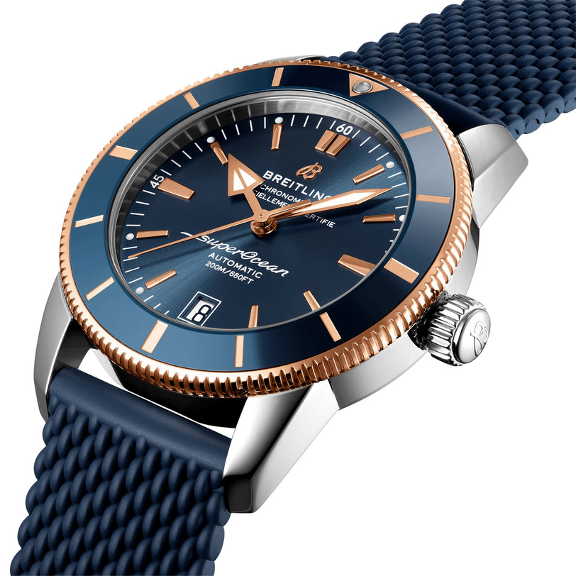 Breitling Superocean Heritage B20 Automatic 42 wristwatch in blue and gold, featuring a date display and textured strap.