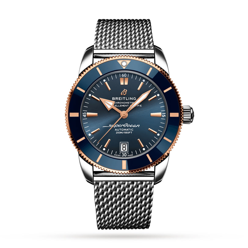 The Breitling Superocean Heritage B20 Automatic 42, featuring a stainless steel case, blue dial with gold accents, luminescent hands, date display, and mesh strap, is displayed against a white background.