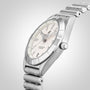 The Breitling Chronomat 32, a stainless steel wristwatch with a cream dial, silver hour markers, and metal bracelet, featuring a COSC-certified SuperQuartz™ movement, is displayed at an angle on a plain light background.