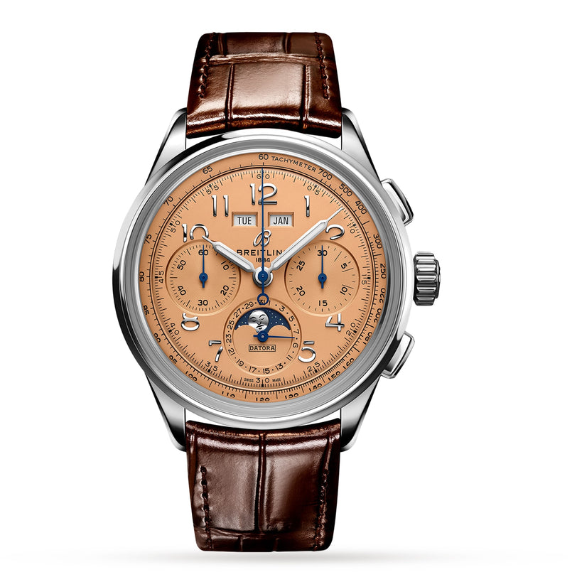 The Breitling Premier B25 Datora 42 is a luxury chronograph featuring a brown leather strap, salmon dial, three subdials, tachymeter scale, 18K red gold case, and a moonphase at 6 o’clock.