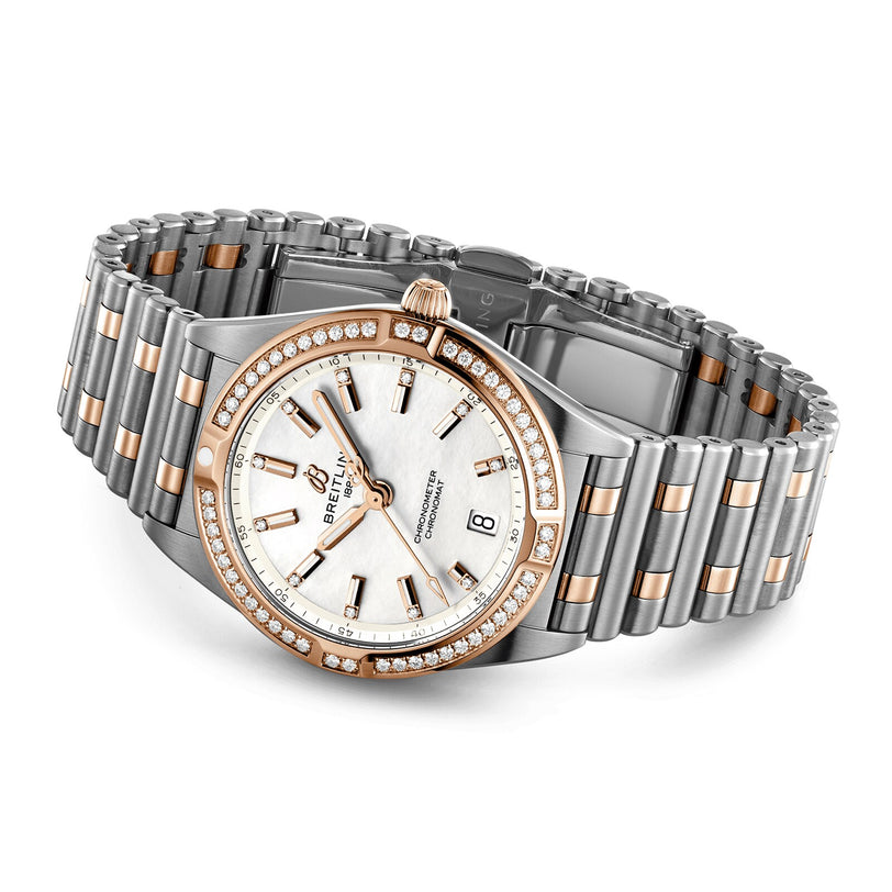 The Breitling Chronomat 32 features a two-tone silver and rose gold metal band, diamond-set bezel, white dial with gold hour markers, and date display.