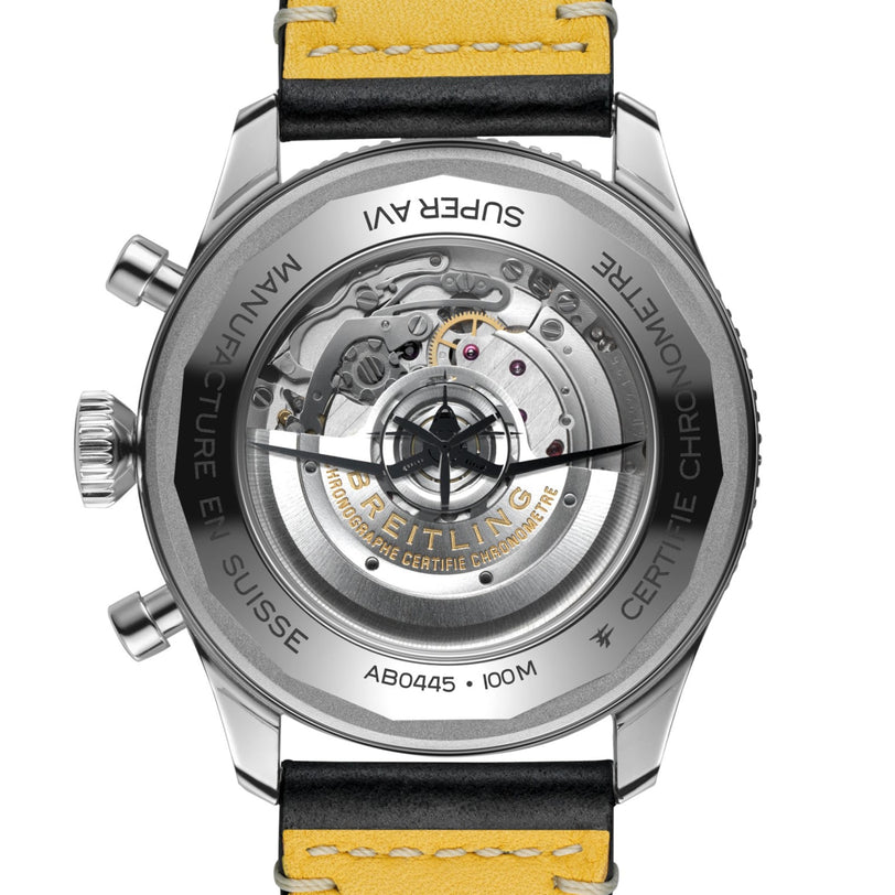 Close-up of the Breitling Super AVI B04 Chronograph GMT 46 Tribute To Vought F4U, highlighting its transparent caseback with visible mechanical movement, engraved details, and yellow leather strap—celebrating the F4U Corsair’s legacy.