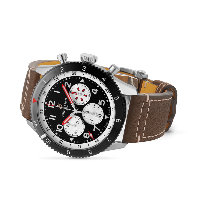The Breitling Super AVI B04 Chronograph GMT 46 Mosquito features a stainless steel case, black and white dial with three subdials, red accents, and a brown leather strap with white stitching—a tribute to aviation history.