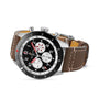 The Breitling Super AVI B04 Chronograph GMT 46 Mosquito features a stainless steel case, black and white dial with three subdials, red accents, and a brown leather strap with white stitching—a tribute to aviation history.