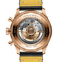 Close-up of the Breitling Super AVI B04 Chronograph GMT 46 P-51 Mustang, highlighting its exposed mechanical movement and engraved gold case with yellow leather strap—honoring the brands storied aviation legacy.