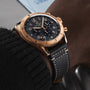 The Breitling Super AVI B04 Chronograph GMT 46 P-51 Mustang features a gold case, black chronograph dial, and a black leather strap with white stitching—showcasing classic aviation heritage style on the wrist.