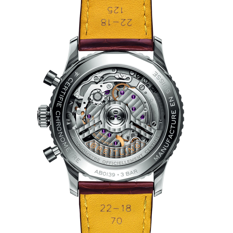 Close-up of the back of the Breitling Navitimer B01 Chronograph 41, showcasing its exposed mechanical movement, engraved details, and signature yellow leather strap.