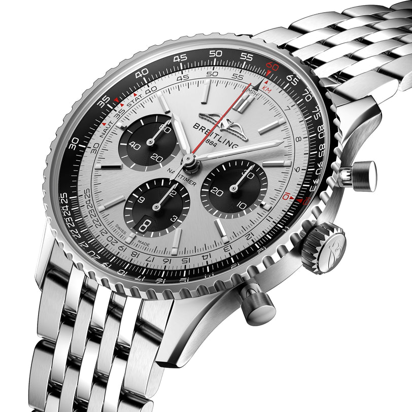 A close-up of the Breitling Navitimer B01 Chronograph 43, a silver wristwatch with a stainless steel band, three black subdials, a bezel tachymeter scale, and powered by the Breitling 01 calibre.