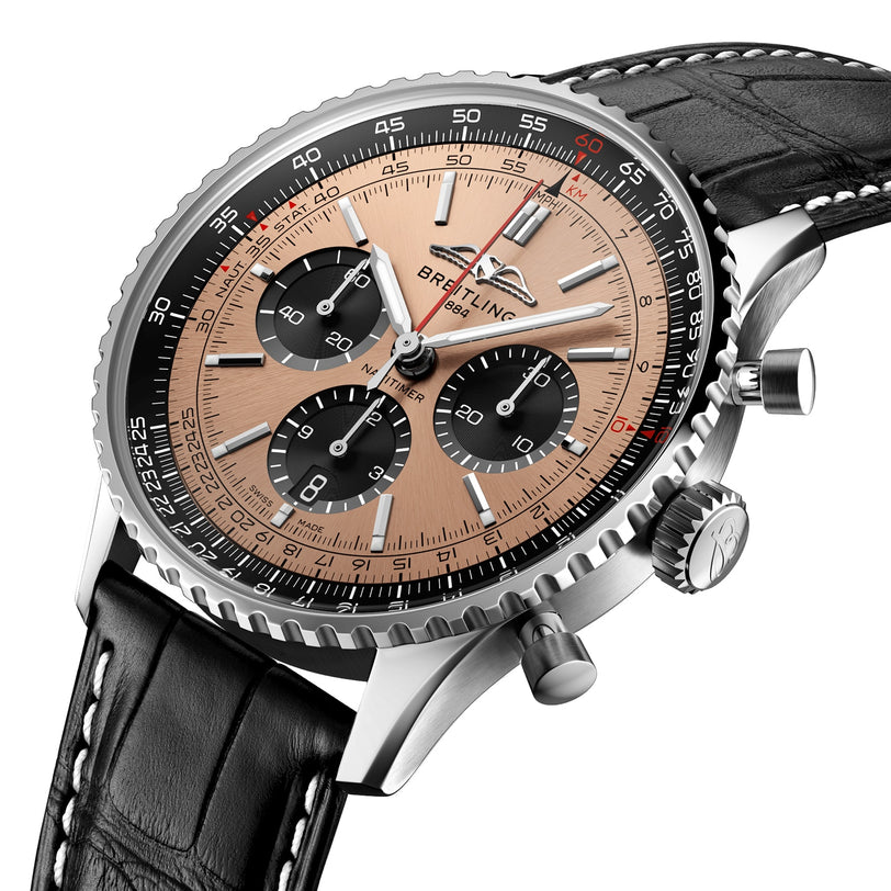 The Breitling Navitimer B01 Chronograph 43 features a stainless steel case, salmon dial with black subdials, black leather strap, silver bezel, and a COSC-certified chronograph movement.