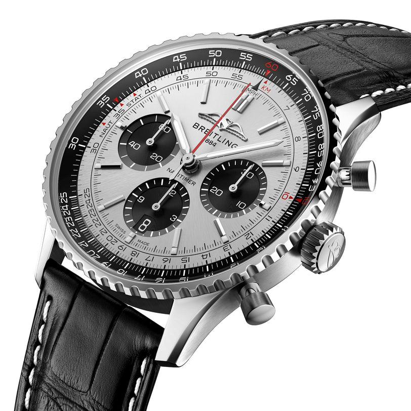 Close-up of the Breitling Navitimer B01 Chronograph 43, featuring a silver dial, black subdials, and a black leather strap with white stitching.
