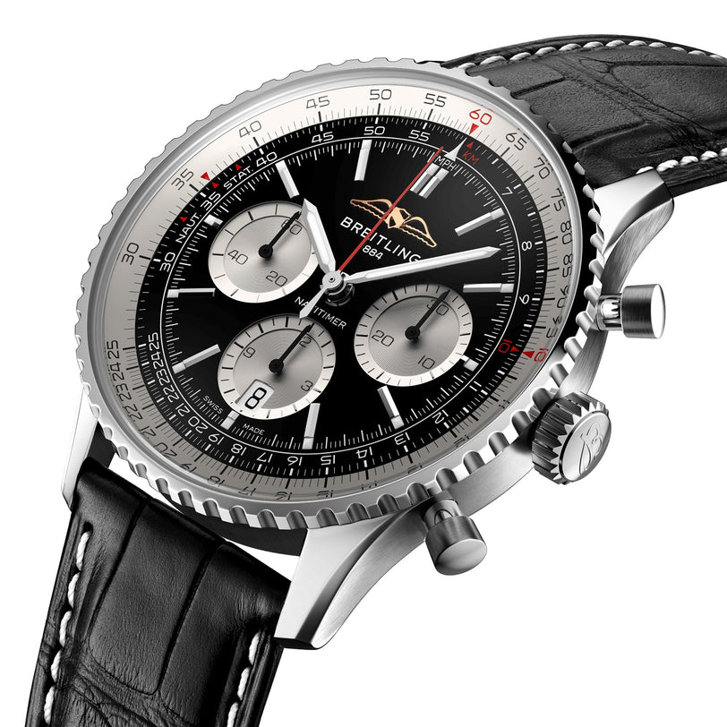 Close-up of a Breitling Navitimer B01 Chronograph 43 with a black dial, three subdials, date window, and a black leather strap featuring white stitching.