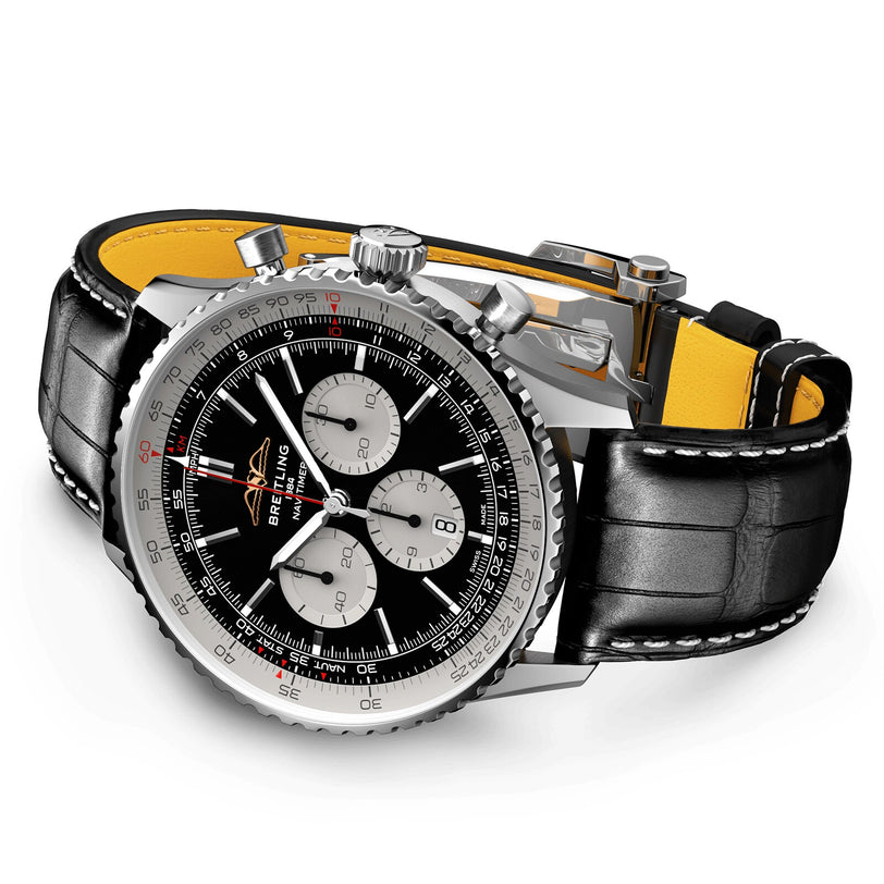 The Breitling Navitimer B01 Chronograph 46 features a black dial with three subdials, a stainless steel case, and a black leather strap with white stitching.