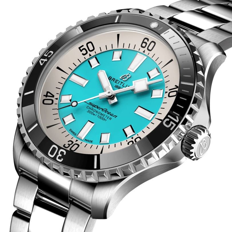 The Breitling Superocean Automatic 44 features a turquoise dial, bold white markers, and a black unidirectional bezel on a stainless steel bracelet—combining water resistance and robust performance.