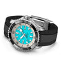 The Breitling Superocean Automatic 44 is a dive watch with a stainless steel case, turquoise dial, black bezel, silver hour markers, and a black rubber strap.