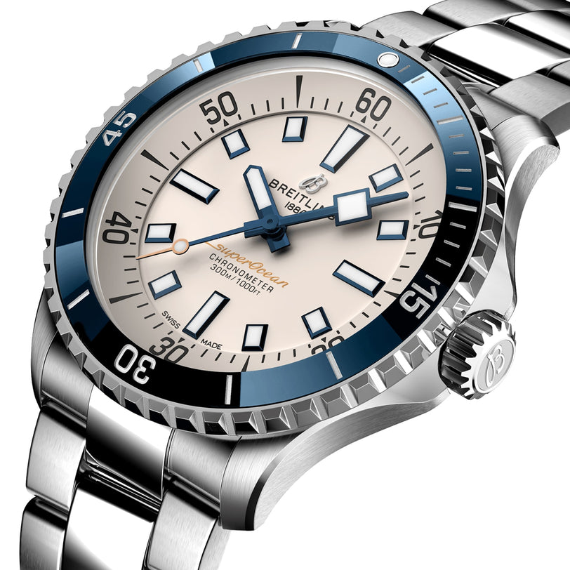 Close-up of the Breitling Superocean Automatic 42 dive watch with a stainless steel case, blue and white bezel, white dial, metal bracelet, and automatic movement.