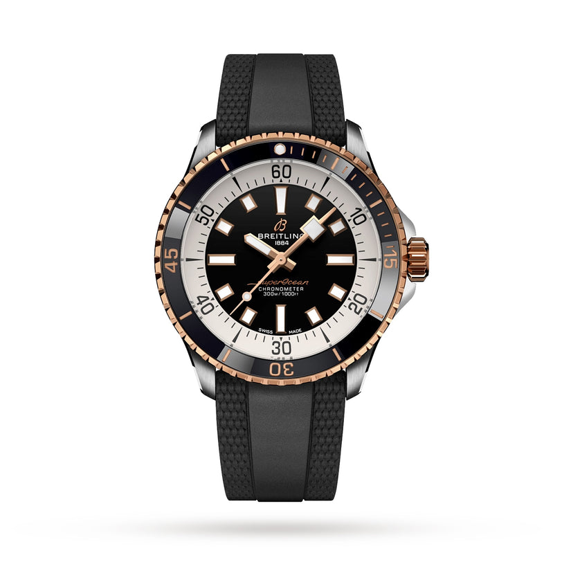 The Breitling Superocean Automatic 42 wristwatch, featuring a black dial, gold and silver bezel, white hour markers, and a black textured rubber strap, is displayed on a white background in classic dive watch style.