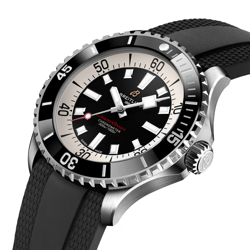 The Breitling Superocean Automatic 46 features a black and white bezel, black dial with white hour markers, red accents, and a water-resistant textured black strap.