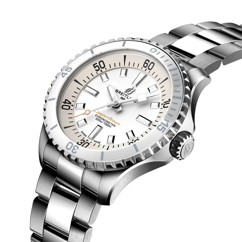 The Breitling Superocean Automatic 36 dive watch features a stainless steel case, white dial, silver hour markers, rotating bezel, and is displayed at an angle on a matching metal link bracelet.