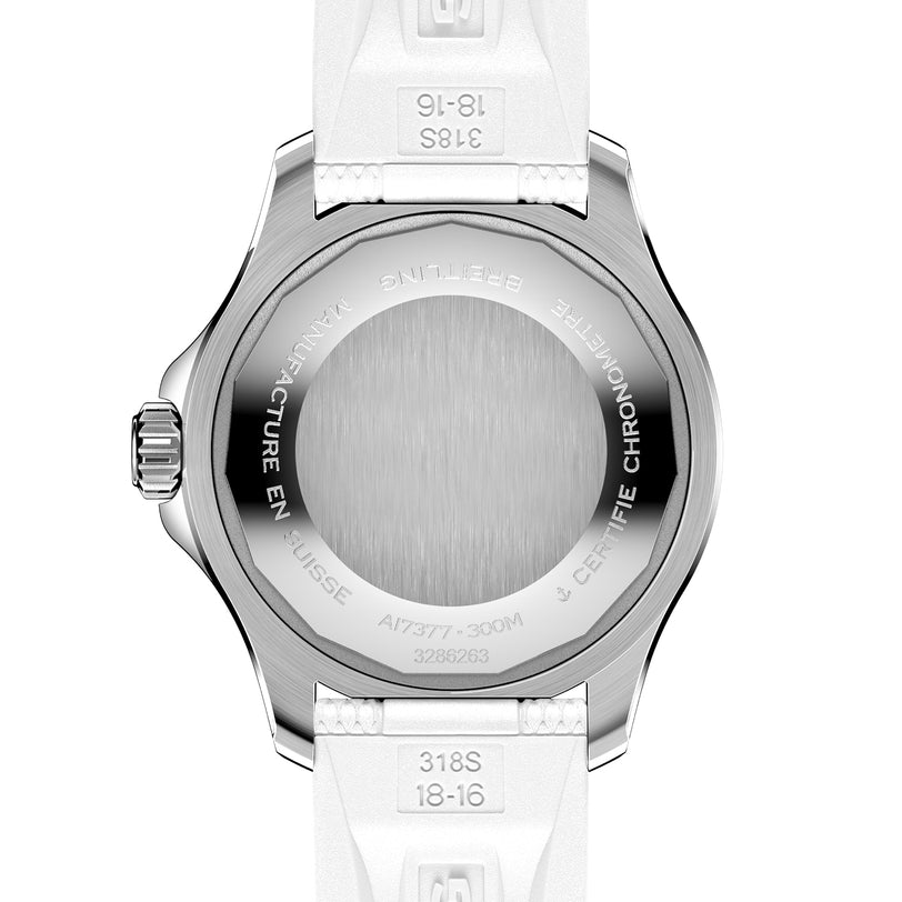 The image shows the back of the Breitling Superocean Automatic 36, featuring a stainless steel case with engraved text, white strap, and ceramic bezel accents.