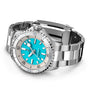 The Breitling Superocean Automatic 36, a stainless steel diving watch, features a turquoise blue dial, silver hour markers, and a ceramic bezel, shown with its metal bracelet partially unclasped.