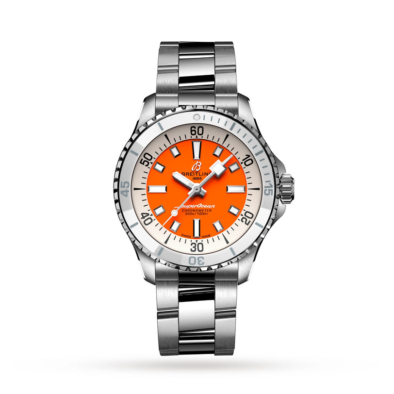 The Breitling Superocean Automatic 36 is a stainless steel dive watch with a silver band and bezel, orange dial, white and black hour markers and hands, automatic movement, water resistance, and the Breitling logo at the top.