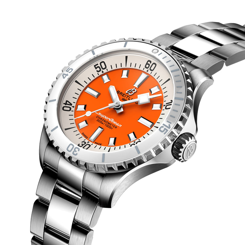 The Breitling Superocean Automatic 36 is a stainless steel dive watch with an orange dial, white hour markers, and a metal link bracelet—shown at an angle and designed with water resistance for durability.