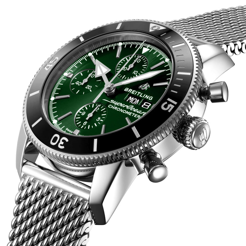 Close-up of the Breitling Superocean Heritage Chronograph 44, featuring a silver case, green dial, mesh metal band, date display, and chronograph functions.