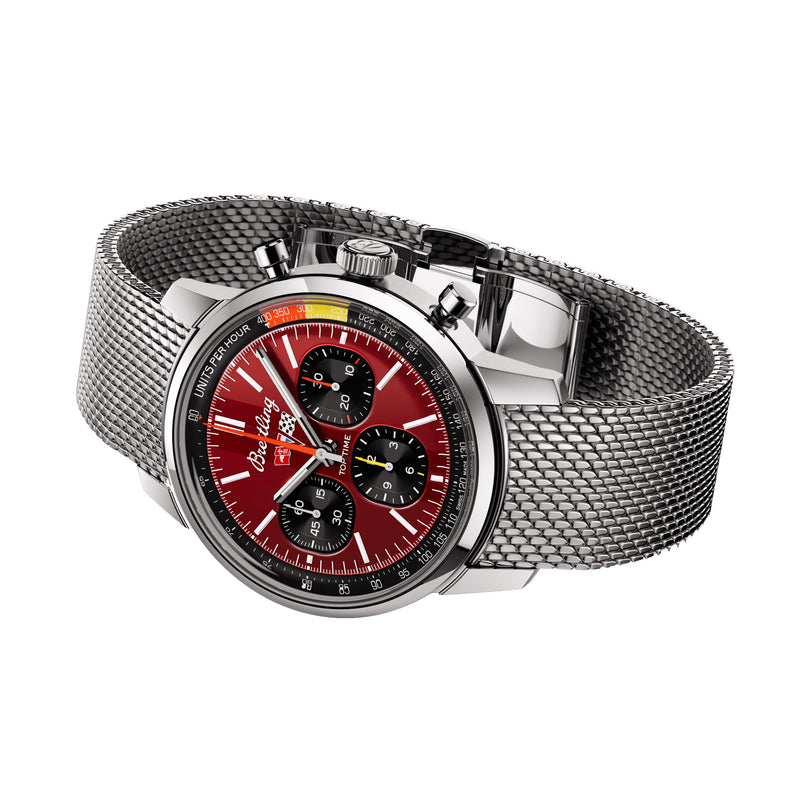 The Breitling Top Time B01 Chevrolet Corvette features a stainless steel mesh band, red dial with black subdials, silver hour markers, racing chronograph functions, and is powered by the Breitling Manufacture Calibre 01.