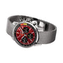 The Breitling Top Time B01 Chevrolet Corvette features a stainless steel mesh band, red dial with black subdials, silver hour markers, racing chronograph functions, and is powered by the Breitling Manufacture Calibre 01.