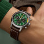 The Breitling Top Time B01 Ford Mustang features a green dial with three subdials, powered by the Manufacture Calibre 01, and paired with a brown perforated leather strap—a nod to classic Mustang style.
