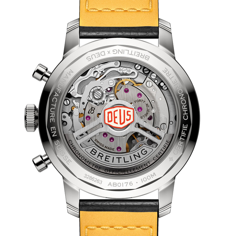 Back view of the Breitling Top Time B01 Deus displays the exposed Manufacture Calibre 01 movement, Deus logo, Breitling branding on the case, and a yellow leather strap.