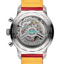 Close-up of a Breitling Top Time B01 Ford Thunderbird watch’s see-through case back, showcasing the Breitling Manufacture Calibre 01 movement, detailed engravings, and a yellow-orange leather strap.