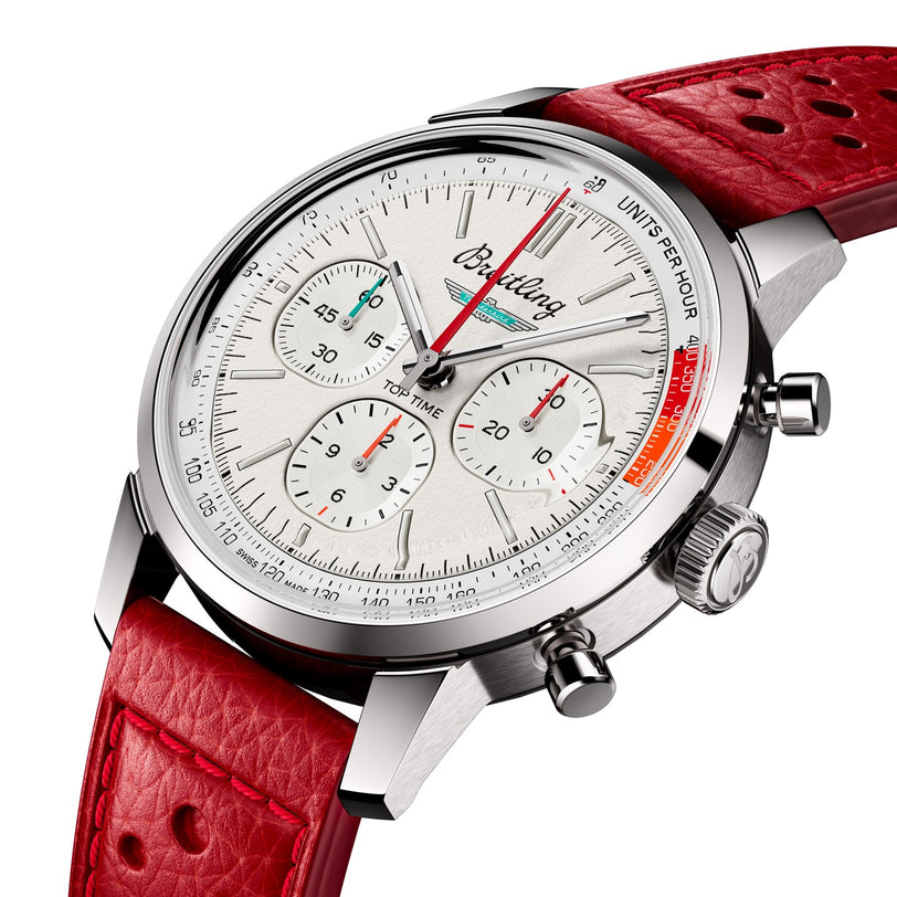 A close-up of the Breitling Top Time B01 Ford Thunderbird, featuring a white dial with three subdials, red leather strap, chronograph pushers, tachymeter bezel, and the Breitling Manufacture Calibre 01 movement.