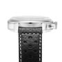 Side view of the Breitling Top Time B01 Triumph wristwatch, featuring a black leather strap with white stitching and holes, stainless steel case, right-side crown, and powered by the Breitling 01 calibre.