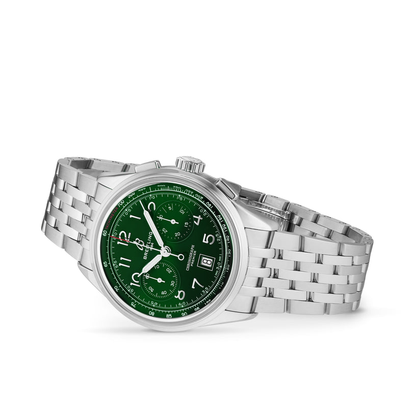 The Breitling Premier B01 Chronograph 42 boasts a green chronograph dial, silver hour markers, and a metal link bracelet, making a striking impression against a white backdrop.