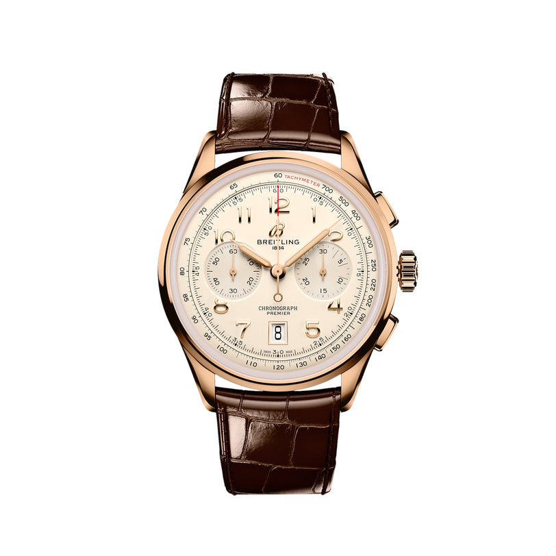 A Breitling Premier B01 Chronograph 42 wristwatch in gold, featuring a cream dial with three subdials, date at 6 o’clock, brown leather strap, and COSC-certified movement, shown on a white background.