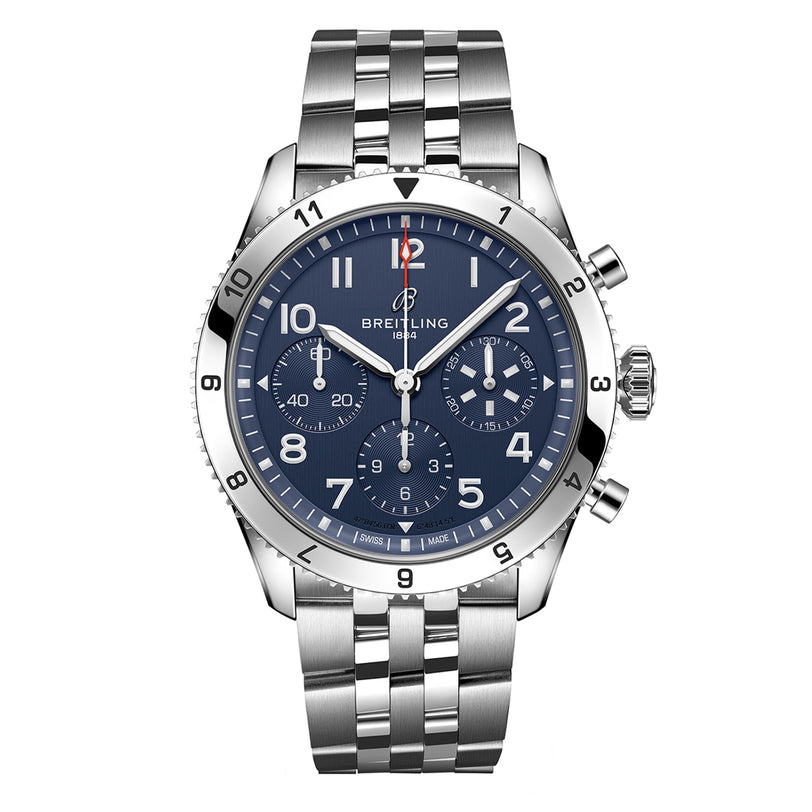 The Breitling Classic AVI Chronograph 42 Tribute To Vought F4U is a stainless steel wristwatch featuring a blue dial, silver hour markers, three subdials, and a link bracelet.
