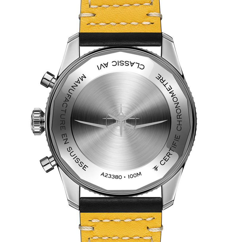 Back view of the Breitling Classic AVI Chronograph 42 Tribute To Vought F4U pilots watch with yellow leather strap, engraved with MANUFACTURE EN SUISSE, 100M, and CERTIFIE CHRONOMETRE, powered by the Breitling 23 calibre.