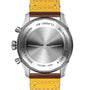 The back view of a Breitling Classic AVI Chronograph 42 Curtiss Warhawk, stainless steel, with a yellow and brown leather strap, engraved MANUFACTURE EN SUISSE, CERTIFIE CHRONOMETRE, and featuring the renowned Breitling 23 calibre.