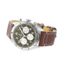 The Breitling Classic AVI Chronograph 42 Curtiss Warhawk features a stainless steel case, olive green dial with three subdials, Breitling 23 calibre movement, and a brown leather strap with white stitching.