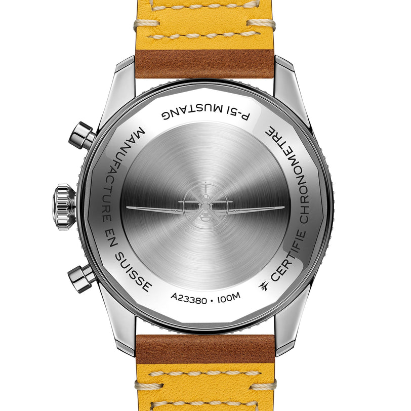 Close-up of the back of a Breitling Classic AVI Chronograph 42 P-51 Mustang with an engraved metal case, pushers, and a brown leather strap with yellow stitching. Powered by the Breitling 23 calibre.