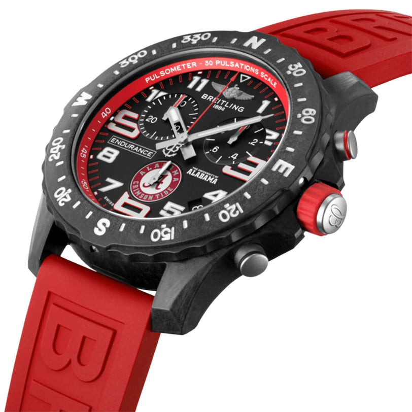 Close-up of the Breitling Endurance Pro 44 The University Of Alabama® watch showcasing a black Breitlight® case, red accents, red rubber strap, and a pulsometer scale on the bezel.