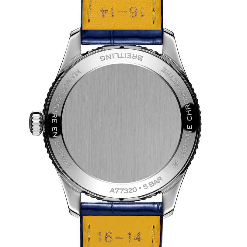 The back of a Breitling Navitimer 32 wristwatch features a metal case, blue and yellow leather strap, and engraved details highlighting the model and specifications.