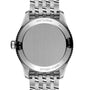 The image shows the back of a Breitling Navitimer 32 stainless steel watch with engraved text and a metal bracelet, highlighting its SuperQuartz™ movement.