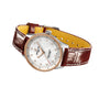 The Breitling Navitimer 32 features a brown leather strap, silver case, beaded bezel, and a white dial with diamond hour markers.