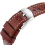 Close-up of a brown leather strap with white stitching and a stainless steel buckle engraved with the Breitling logo, complementing the Navitimer 32’s classic style.