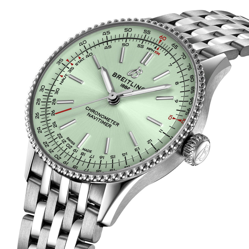 Close-up of the Breitling Navitimer Automatic 36, showcasing a mint green dial, silver hour markers, and metal bracelet, powered by the Breitling 17 movement.
