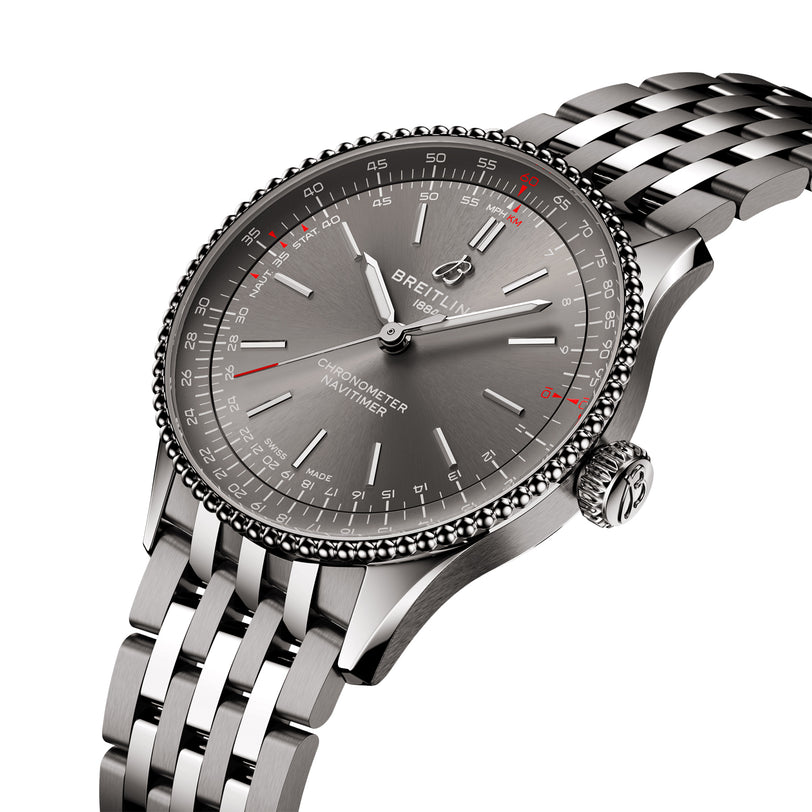 The Breitling Navitimer Automatic 36 is a stainless steel chronograph wristwatch featuring a gray dial, date display, silver hour markers, and a metal link bracelet.